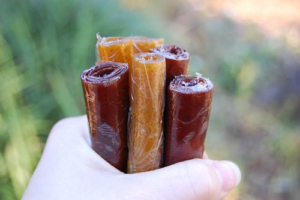 image of hand holding homemade fruit rolls