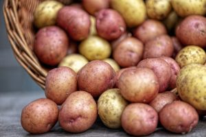 Image of a photo of red and white potatoes overflowing from a basket