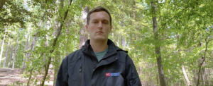 Franklin County extension Horticulture agent, Colby Griffin standing in a wooded are