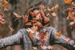 leaves falling on a lady 