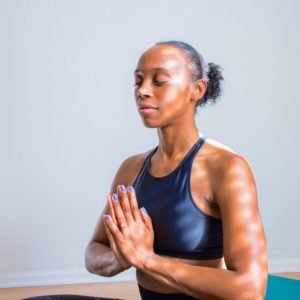 lady meditating in workout clothes