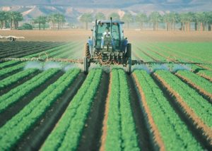 farmer on a tractor spraying crops