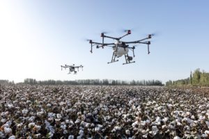 drones flying over cotton field