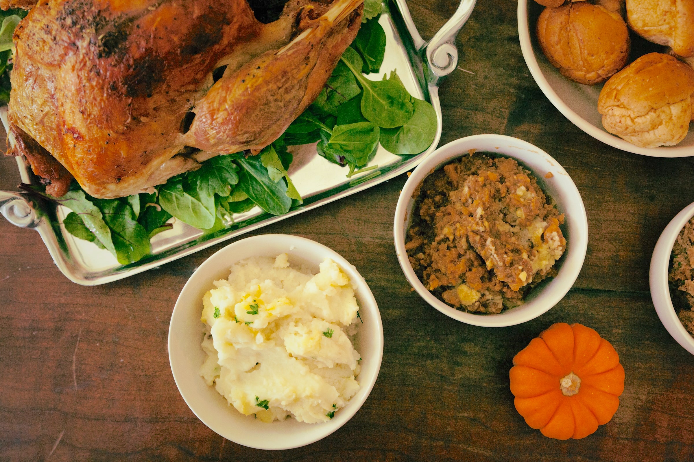 Thanksgiving dinner turkey and dressing, potatoes and a pumpkin