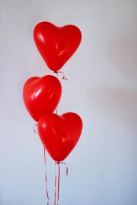 Photo of 3 red heart-shaped balloons by Kristina Paukshtite from Pexels