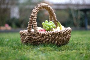 full picnic basket sitting on the grass
