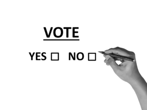 check box to vote yes or no, hand holding pen