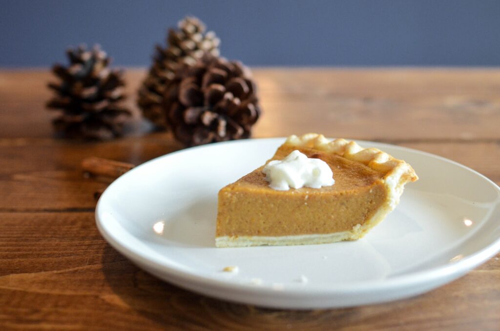 slice of pumpkin pie on white saucer