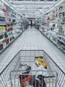 half-full grocery shopping cart in the aisle