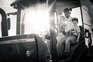 Jason Brown and 2 children on a tractor