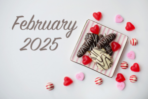 February 2025 on a cookie plate and candy in the background