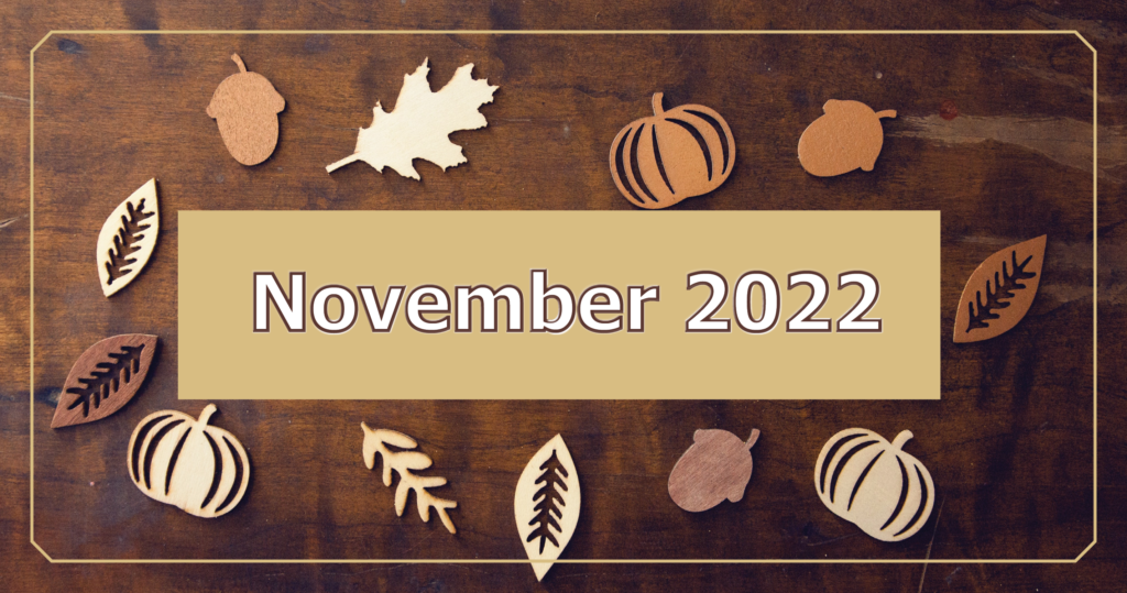November 2022 heading on a wooden plaque with leaves and acorns