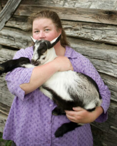 Debbie Roos with a goat.