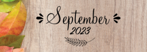 September 2023 on tree trunk with colored leaves background