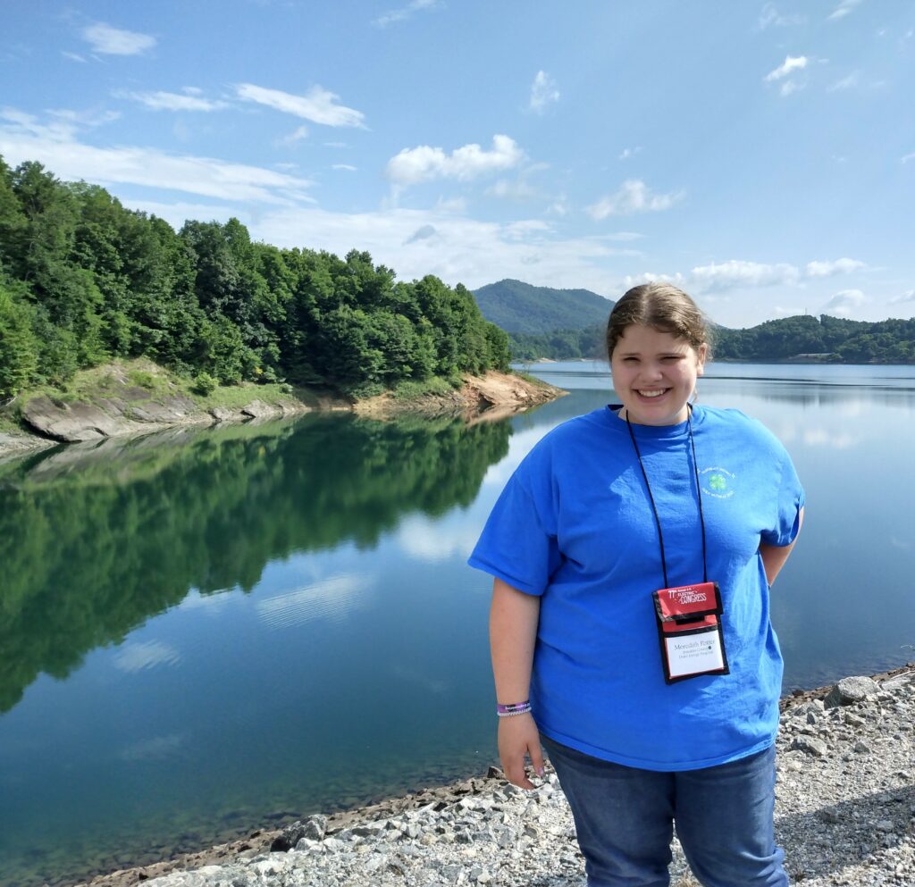 Meredith is standing at the Bad Creek Dam.