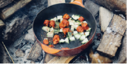 pot of vegetables cooking on a wood fire